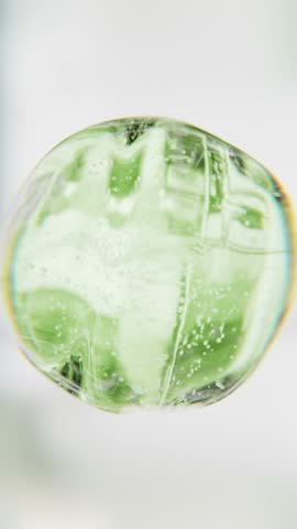 Green aloe vera serum bubble. Organic eco skincare cosmetics macro 3D abstract background. Natural moisturizer essence gel drops. Collagen fluid molecule, detox peptide face lotion for skin renewal