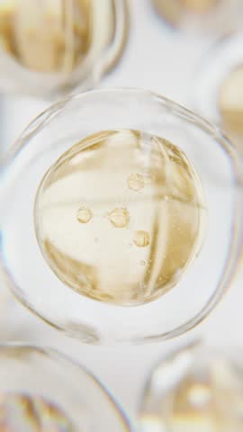 Golden serum liquid bubble. Luxury beauty cosmetics macro 3D abstract background. Bio moisturizer essence gel or oil drops. Collagen fluid molecule. Moisturizing peptide face cream for skin lifting