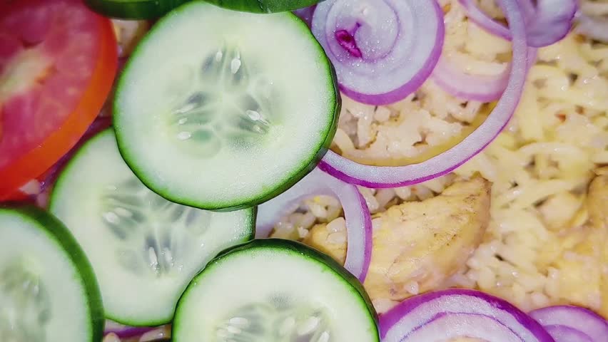 Delicious Homemade Chicken Biryani Served With Fresh Sliced Salad Vegetables