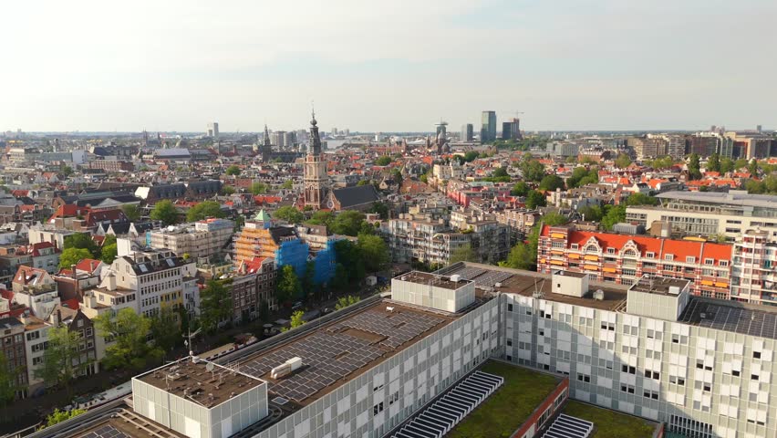 Amsterdam Aerial Drone View Over Historic Canal Houses Featuring Church Spire and City