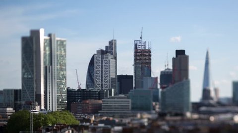 beautiful timelapse of the skyline of london shot with a tilt shift lens, leaving some buildings in sharp focus with a blur on the rest
