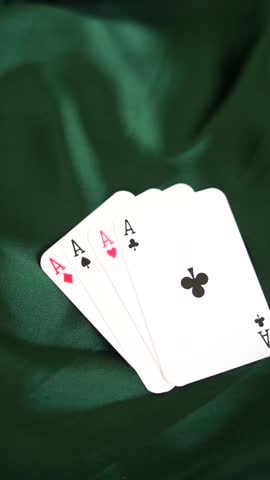 Four aces playing cards arranged on dark green elegant fabric background poker game gambling