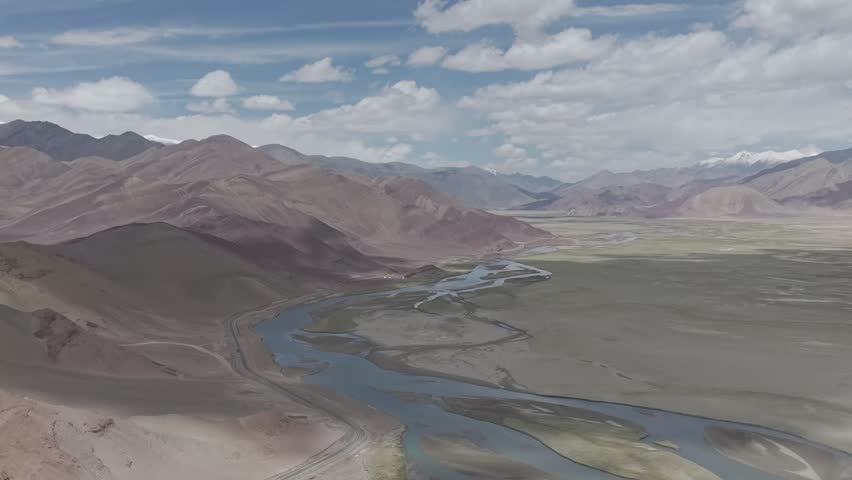 Beautiful high-altitude mountain landscape in Ladakh with dramatic rocky terrain and clear skies.