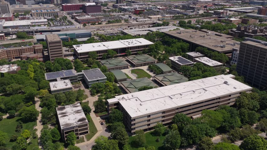 University of Illinois Chicago campus buildings surrounded by green trees in the Near West Side neighborhood, modern urban architecture and education