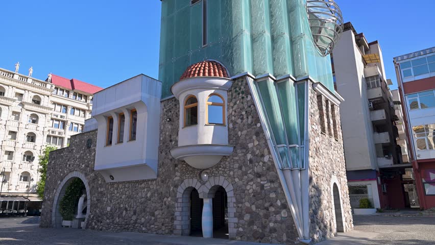 Modernist architecture of the Mother Teresa Memorial House in Skopje, North Macedonia. Sunny day view of the unique facade with stone and glass