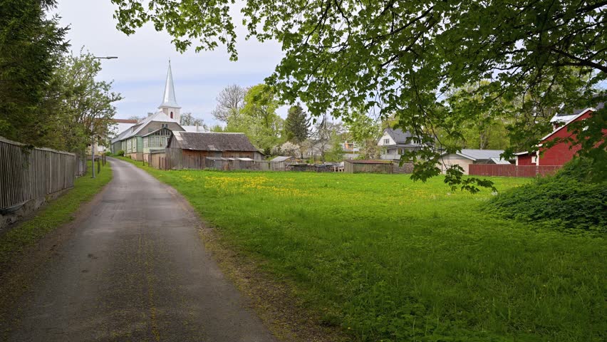 Picturesque small town scenery showing a walk along a narrow street with the steeple of St. John