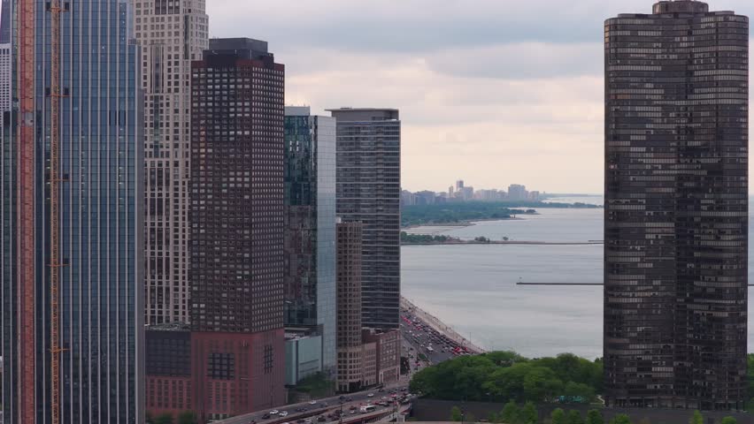 Urban landscape revealing Chicago skyline with Lake Michigan and congested traffic on North Lake Shore Drive, modern architecture and cityscape development