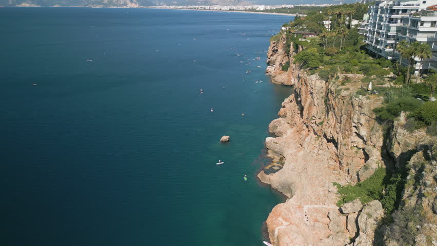 Aerial view of Antalya rocky cliffs with luxury hotels and deep blue sea