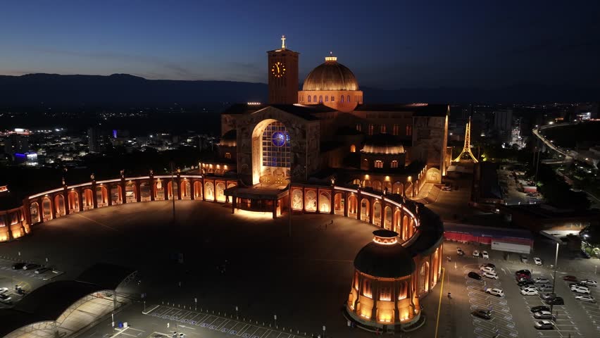 Catholic Temple In Aparecida Sao Paulo Brazil. Breathtaking Aerial View Of Famous Church In The City. Night Illuminated Skyline. Downtown Cityscape. Aparecida Sao Paulo.