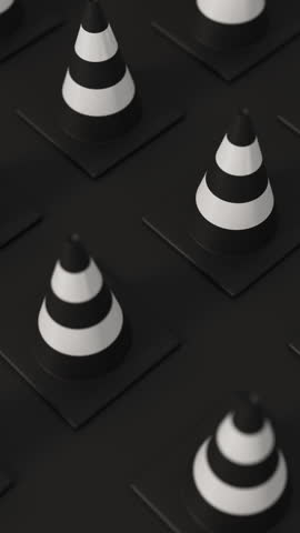 High angle grid of traffic cones in white and black on a black background for road safety and construction warning. Vertical video.