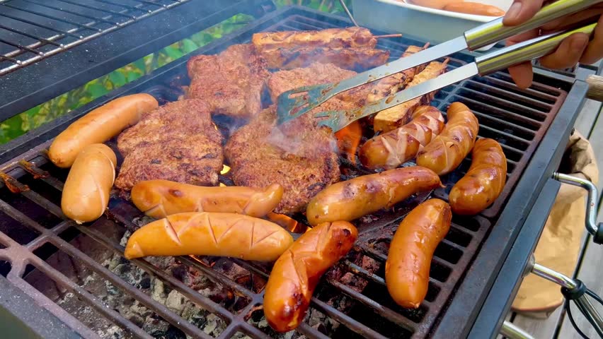 Grilling Sausages and Meat on Outdoor Barbecue Grill