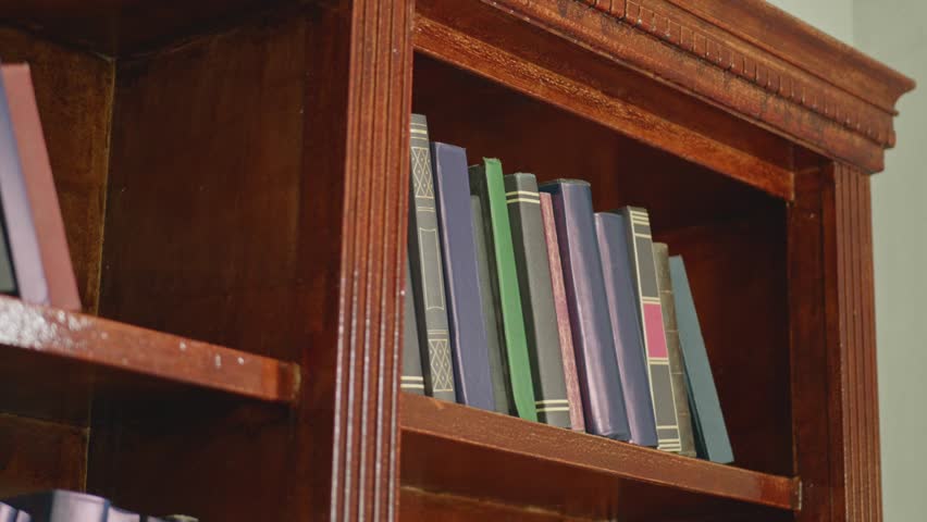 Old Leather Bound Books on Wooden Library Shelves