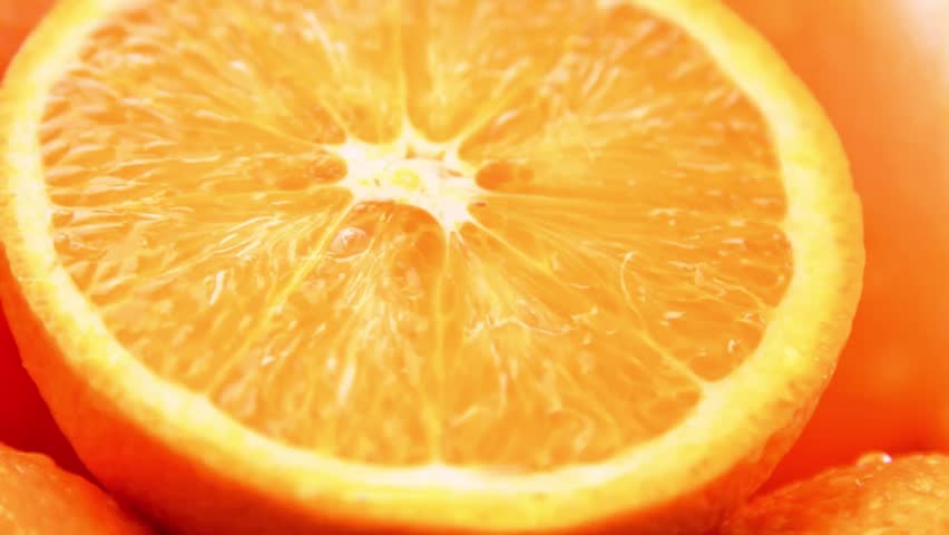 A bright and mouth-watering close-up of a freshly sliced orange half, showcasing its juicy texture and rich citrus details. Perfect for healthy eating and summer fruit content.
