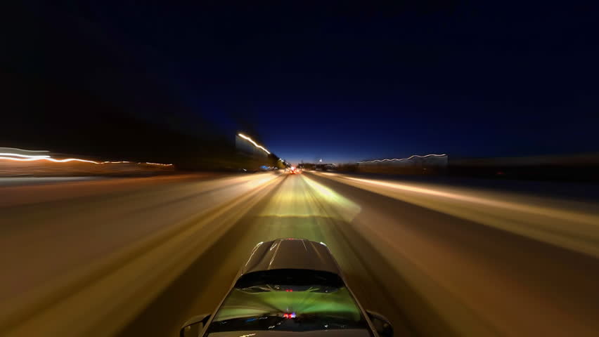 Taxi cab point of view time lapse hyperlapse through night Barrie city near lake Simcoe area. North America Canada. Long exposure timelapse of city traffic. Speedy car front POV view driving plate.