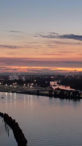 Aerial Sunset Over New Westminster, British Columbia, Canada: City Lights Reflecting on Fraser River
