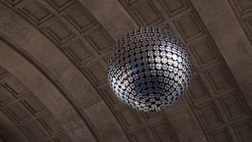 Large mirrored sphere sculpture hangs beneath an arched coffered ceiling inside Zurich train station.