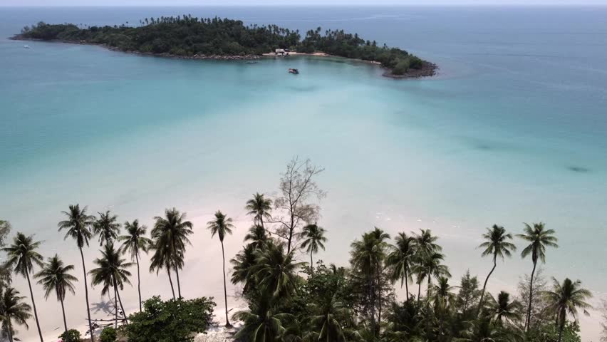 A drone footage of the greenery forest and sandy coastal beach in Koh Kood,  Thailand on a summer day