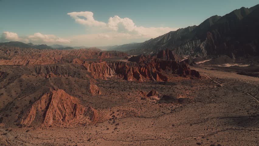 Aerial view of Valles Calchaquies with red rock formations and desert landscape in San Carlos, Salta, Argentina.