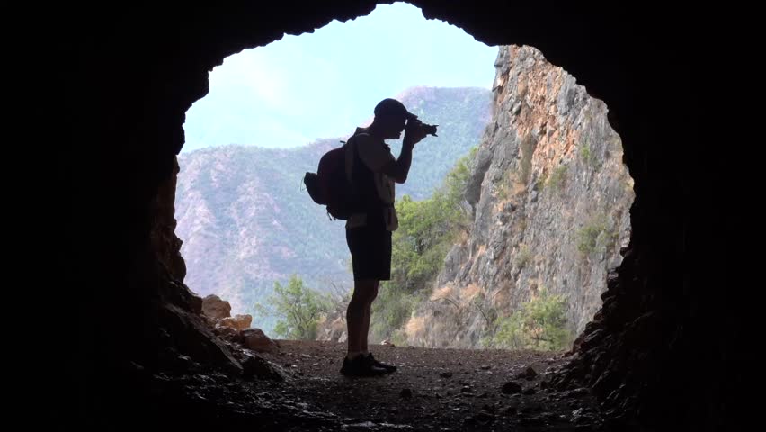 A silhouette of Caucasian photographer