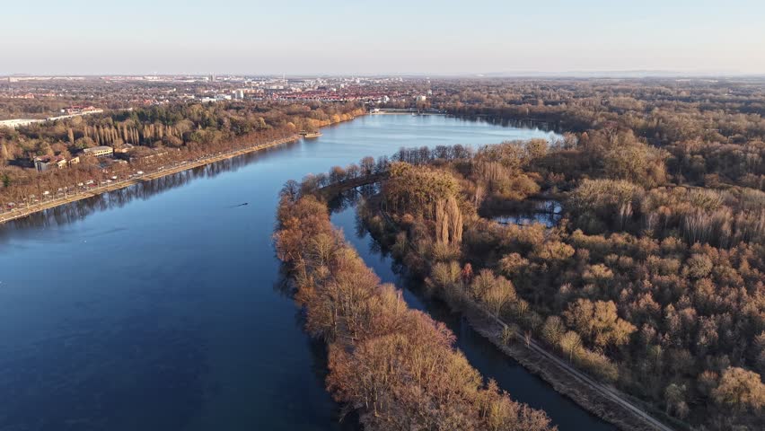 Aerial view of Maschsee lake surrounded by lush trees and urban landscape in Hanover, Lower Saxony, Germany.