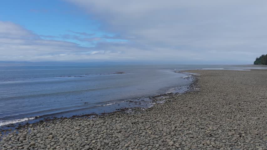 Peaceful Ocean Waves Gently Lapping a Rocky Beach on Vancouver Island, British Columbia