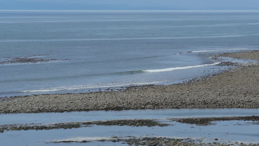 Gentle Waves Lap on Rocky Shore of Vancouver Island, British Columbia Coast