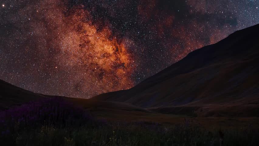 Night landscape, mountains under bright colorful milky way galaxy. Space, night scene time lapse.