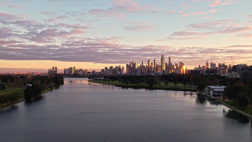 Sunrise view of Yarra river and Melbourne skyscrapers business office building with evening skyline in Victoria, Albert Park, Australia