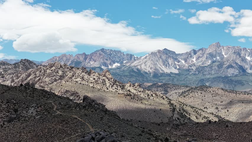 Aerial view of the rugged Alabama Hills rock formations and the towering Sierra Nevada mountain range in California