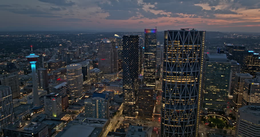 Calgary AB Canada Aerial v69 dusk hyperlapse drone fly around capturing panoramic panning views of downtown cityscape with light up streets and skyscrapers - Shot with 5k Camera - July 2023