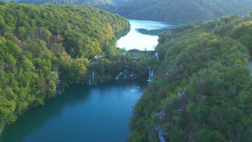 Beauty nature with waterfall. Panoramic aerial view of waterfalls. Beauty green nature. Plitvice lakes and Waterfall. Beauty waterfall landscape in Croatia. Summer view of Plitvice lakes.
