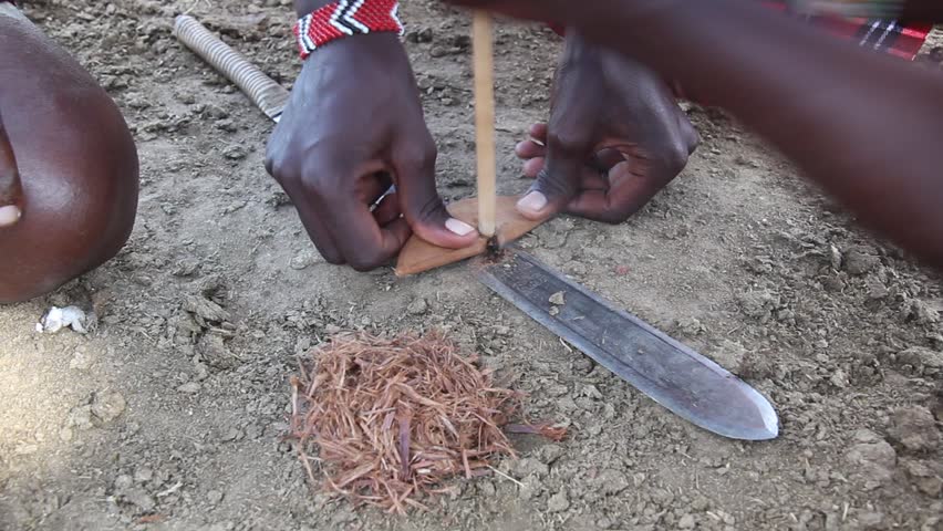 Detail of Masai men making a fire, Kenya