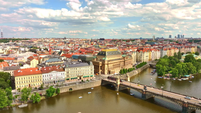 Theatre in Prague city. Opera heritage across water. Theatre historic Prague city center. Theatre stands iconic in Prague near Vltava River. Praha city theatre. Prague opera aerial view.