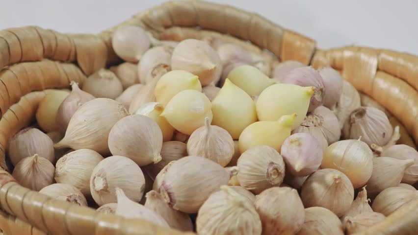 Dried garlic cloves on the background.