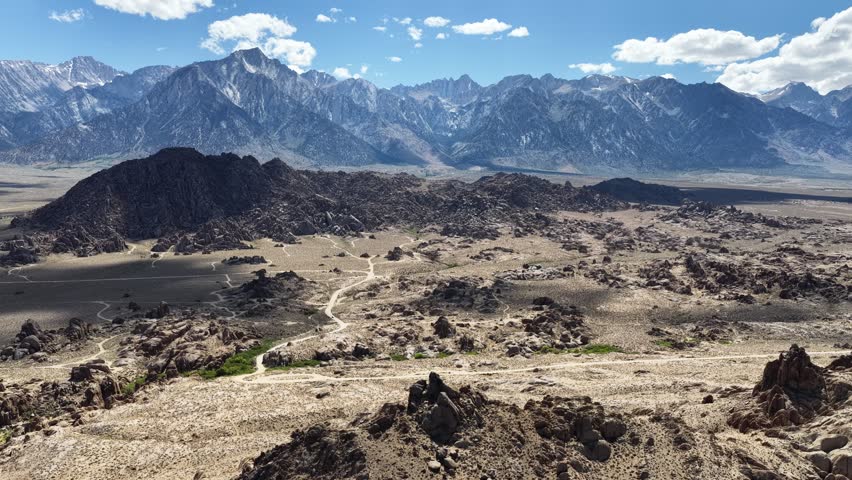 Elevated view of the Alabama Hills rock formations and the snow-capped Sierra Nevada mountain range in California