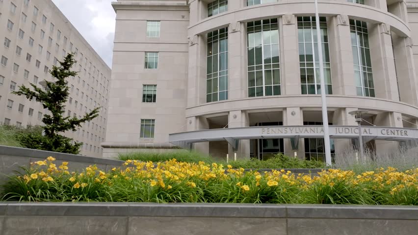 Exterior of Pennsylvania Judicial Center in Harrisburg, Pennsylvania with drone moving low left to right.