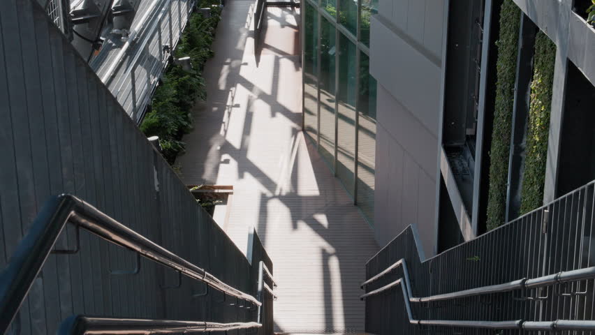 Tokyo Scene  :  Descending the Urban Steps Toward the Sunlit Wooden Deck  |  Ikebukuro, Tokyo, Japan