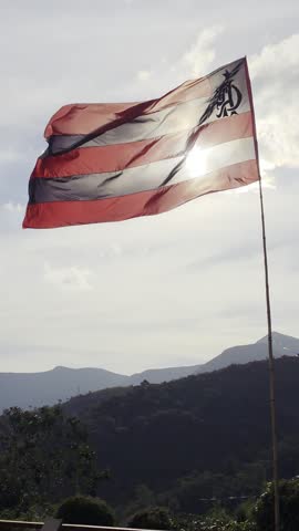 Flamengo Flag Waving Against the Sky in Brazil with Mountain Landscape