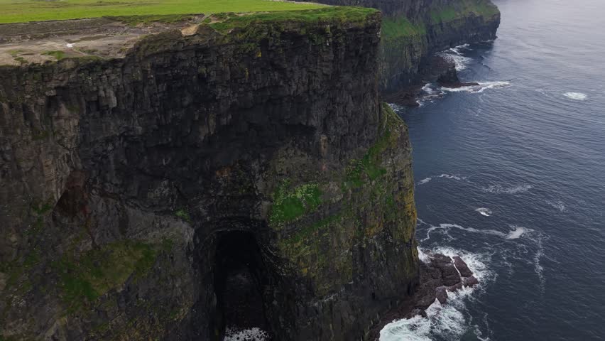 Steep Cliffside Of Moher Rises Above The Atlantic Ocean Along The West Coast Of County Clare, Ireland. Aerial Shot