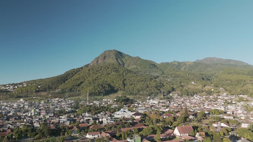 Breathtaking Aerial View of a Scenic Mountain Overlooking a Picturesque Town