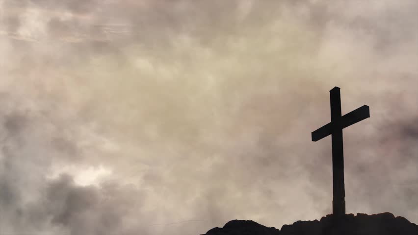 Silhouette of Christian Cross Against Glowing Dramatic Storm Clouds