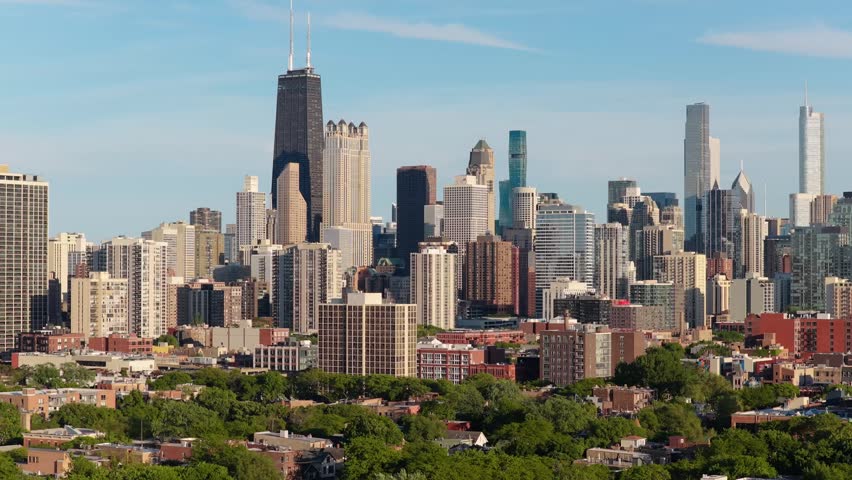 Majestic Chicago skyline revealing urban panorama with iconic skyscrapers John Hancock Center and St. Regis Tower under sunny skies, Illinois, USA
