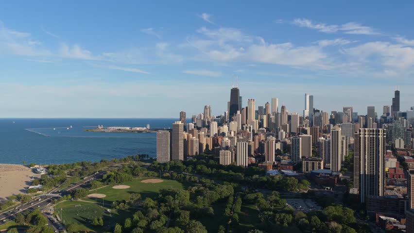 Chicago skyline showing Lincoln Park South Fields and North Avenue Beach with Lake Michigan waters during a sunny morning from the Gold Coast and Old Town neighborhoods
