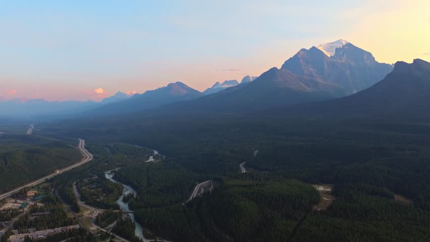 Cinematic shot revealing a beautiful Louise lake, surrounded by tall trees and mountains
