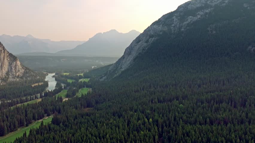 Capturing Banff Avenue, Bow river with turquoise water, picturesque townscape surrounded by forested valleys and mountain ranges in Alberta, Canada.