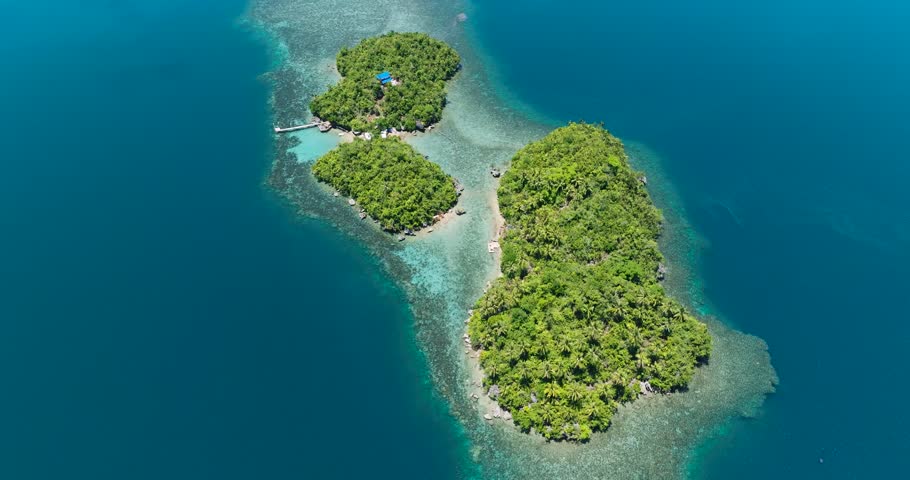 Tropical island with beach and blue sea. Bangkay Island. Mindanao, Philippines.