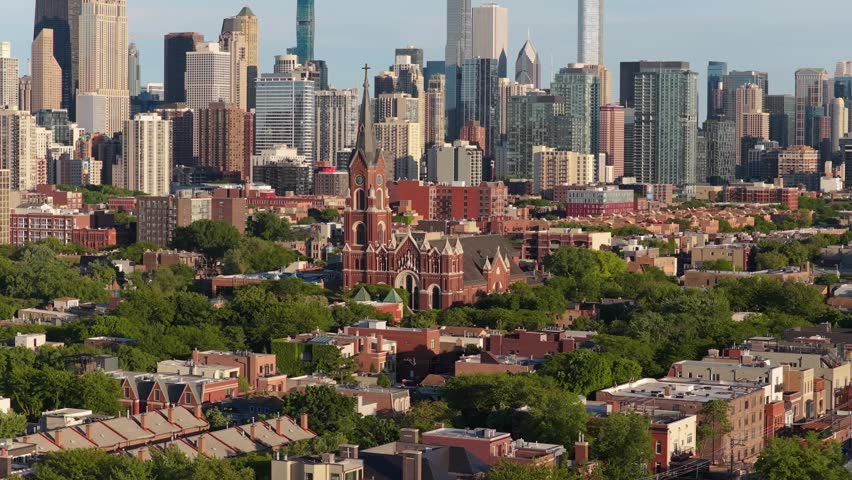 St. Michaels Church in Old Town neighborhood and historic architecture with downtown city skyline visible background on sunny day
