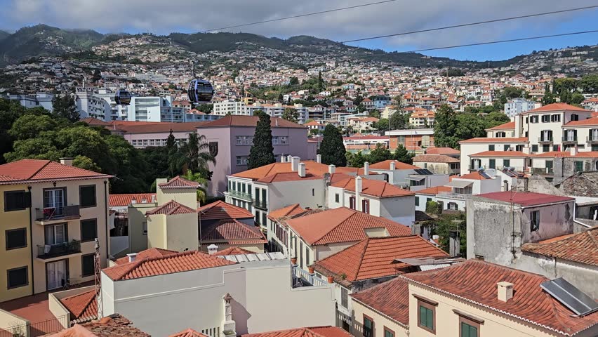 Funchal Cable Car soaring above Santa Maria Maior and Zona Velha rooftops, Madeira, Portugal