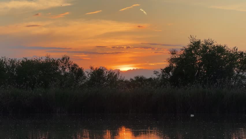 Beautiful time lapse with colorful clouds over the small pond