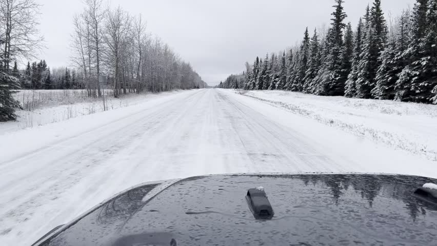 Driving on an icy, snowy road in interior Alaska on an autumn day. 